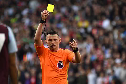 Premier League 2024-25: Referee Michael Oliver shows yellow card during Aston Villa vs Arsenal match